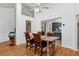 Bright dining room featuring wood floors, tall ceilings, and seamless connection to the kitchen at 10400 Hunters Trail Ct, Orlando, FL 32817