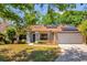 Charming brick home with well-manicured lawn, solar panels, and inviting walkway at 10400 Hunters Trail Ct, Orlando, FL 32817
