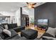 Open-concept living room with hardwood floors and stylish furniture, leading to a kitchen at 10400 Hunters Trail Ct, Orlando, FL 32817