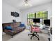 Office space features futon, chair, dual monitors, and a large window for natural light at 10400 Hunters Trail Ct, Orlando, FL 32817