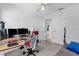 Office space features desk, chair, dual monitors, and a view into an ensuite bathroom at 10400 Hunters Trail Ct, Orlando, FL 32817