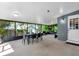 Cozy patio with screened windows, dining furniture, and pleasant outdoor views at 10400 Hunters Trail Ct, Orlando, FL 32817