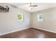 This bedroom features wood floors and two windows providing natural light at 1103 Timor Ave, Orlando, FL 32804