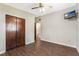 Bedroom features wood floors, closet, mounted TV, and ceiling fan at 1103 Timor Ave, Orlando, FL 32804