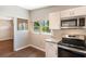 Bright kitchen with modern appliances, granite countertops, and white cabinets with lots of light at 1103 Timor Ave, Orlando, FL 32804
