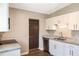 Bright kitchen with stainless steel dishwasher, granite countertops, and white cabinets at 1103 Timor Ave, Orlando, FL 32804