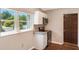 Well-lit kitchen featuring granite countertops, stainless steel appliances, and white cabinetry at 1103 Timor Ave, Orlando, FL 32804