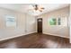 Inviting living room with wood-look flooring, a ceiling fan, and two windows for ample natural light at 1103 Timor Ave, Orlando, FL 32804