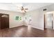 Comfortable living room with wood-look flooring, ceiling fan, natural light, and access to the bathroom at 1103 Timor Ave, Orlando, FL 32804