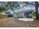 View of the home's backyard featuring a patio and mature trees at 113 Golden Crest Ct, Winter Springs, FL 32708