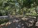 The backyard contains mature trees, wood features, and shade at 113 Golden Crest Ct, Winter Springs, FL 32708