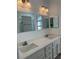 Bathroom featuring a double vanity with quartz countertops, modern fixtures, and ample lighting at 113 Golden Crest Ct, Winter Springs, FL 32708
