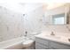 Bathroom with white marble tile, modern fixtures, and a tub/shower combo at 113 Golden Crest Ct, Winter Springs, FL 32708
