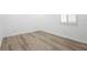 A bedroom with light walls, wood-look floors, and natural light at 113 Golden Crest Ct, Winter Springs, FL 32708