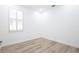 Empty, bright bedroom with a large window and wood-look floors at 113 Golden Crest Ct, Winter Springs, FL 32708