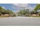 Elegant gated community entrance with brick signage and lush landscaping under a partly cloudy sky at 113 Golden Crest Ct, Winter Springs, FL 32708