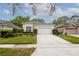 Well-maintained home featuring a two-car garage, manicured lawn, and trimmed hedges for curb appeal at 113 Golden Crest Ct, Winter Springs, FL 32708