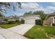 Well-maintained home featuring a two-car garage, manicured lawn, and trimmed hedges for curb appeal at 113 Golden Crest Ct, Winter Springs, FL 32708