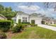 Charming single-story home with manicured landscaping, lush green lawn, and a bright green front door at 113 Golden Crest Ct, Winter Springs, FL 32708