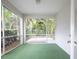 Screened in lanai with a view of the green backyard and trees at 113 Golden Crest Ct, Winter Springs, FL 32708