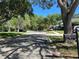 Neighborhood street view with mature trees and well-maintained lawns on a sunny day at 113 Golden Crest Ct, Winter Springs, FL 32708
