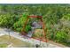 Aerial view of a single Gathering home nestled amongst trees on a large lot at 1234 1St Ave, Deland, FL 32724