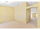 Spacious room featuring neutral carpet, paint, and arched doorway at 1234 1St Ave, Deland, FL 32724
