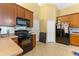 Efficient kitchen with black appliances, wooden cabinets and neutral colored flooring at 1234 1St Ave, Deland, FL 32724