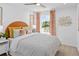 Bright bedroom with a large window, modern decor, and a comfortable bed at 1287 Tarflower Dr, Winter Springs, FL 32708