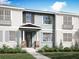 Charming townhome featuring a covered porch, stone accents, and a well-manicured front yard at 1287 Tarflower Dr, Winter Springs, FL 32708