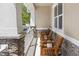 Inviting front porch with chairs and stone accents, perfect for relaxing outdoors at 1287 Tarflower Dr, Winter Springs, FL 32708