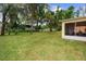 Private backyard with lush greenery and partial view of screened in porch, ideal for outdoor enjoyment at 1304 Independence Ln, Mount Dora, FL 32757