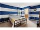 Nautical-themed bedroom offering natural light, modern design, and an adjacent bathroom at 1304 Independence Ln, Mount Dora, FL 32757