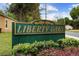 Liberty Oaks neighborhood sign with lush landscaping and green and gold sign at 1304 Independence Ln, Mount Dora, FL 32757
