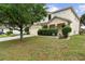 Inviting two-story home with a well-manicured lawn and stone-accented entryway at 1304 Independence Ln, Mount Dora, FL 32757