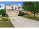 Charming two-story home with a spacious driveway and meticulously landscaped front yard at 1304 Independence Ln, Mount Dora, FL 32757