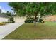 Well-maintained single-Gathering home featuring a lush green lawn and a two-car garage at 1304 Independence Ln, Mount Dora, FL 32757