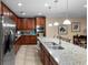 Modern kitchen featuring stainless steel appliances and a granite countertop island at 1304 Independence Ln, Mount Dora, FL 32757