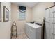 Functional laundry room equipped with a washer, dryer, and ample storage options at 1304 Independence Ln, Mount Dora, FL 32757