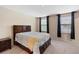 Main bedroom boasts natural light, neutral tones, and bedside tables for your convenience at 1304 Independence Ln, Mount Dora, FL 32757