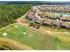 This aerial view shows the proximity of the home to the golf course and surrounding natural wooded and wetland areas at 13349 Alderley Dr, Orlando, FL 32832