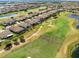 An aerial view of a beautiful, manicured golf course community and shows the surrounding water and natural areas at 13349 Alderley Dr, Orlando, FL 32832