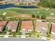 An aerial view shows a home with a clay tile roof, manicured landscaping, and access to a neighborhood golf course at 13349 Alderley Dr, Orlando, FL 32832