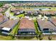 A beautiful aerial view of the neighborhood showcases a large home with a screened pool and manicured landscaping at 13349 Alderley Dr, Orlando, FL 32832