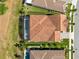 An aerial view shows a home with a clay tile roof, screened pool, backyard patio, and professionally landscaped yard at 13349 Alderley Dr, Orlando, FL 32832