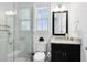 Bathroom featuring a glass shower, granite counters, black cabinetry, and modern fixtures at 13349 Alderley Dr, Orlando, FL 32832