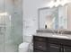 Bright bathroom with glass shower, granite counters, and dark wood cabinets at 13349 Alderley Dr, Orlando, FL 32832