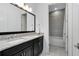 Bathroom with black cabinets, granite counters and large mirror over double sinks at 13349 Alderley Dr, Orlando, FL 32832