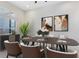 Dining area featuring stylish decor, neutral walls, modern light fixture, and elegant artwork at 13349 Alderley Dr, Orlando, FL 32832