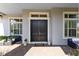 Inviting front entrance with elegant double doors, stylish decor, and a comfortable seating area at 13349 Alderley Dr, Orlando, FL 32832